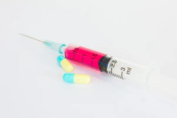 Syringe with red liquid on white background — Stock Photo, Image