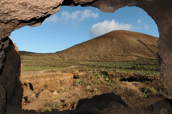 Cave near a volcano in the desert — Stock Photo, Image