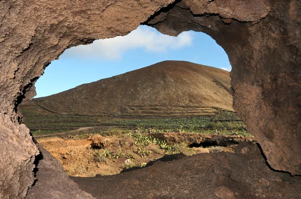 Cave near a volcano in the desert — Stock Photo, Image