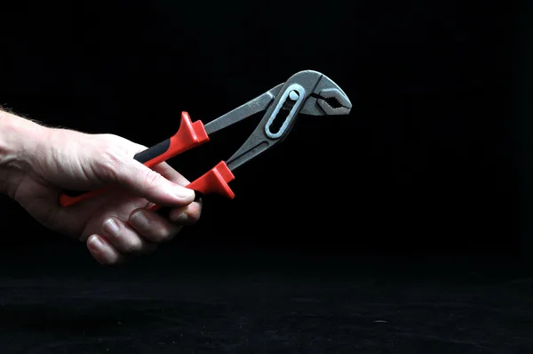 Pliers and a Hand — Stock Photo, Image