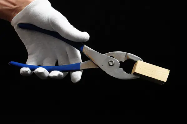 Pliers and a Hand — Stock Photo, Image