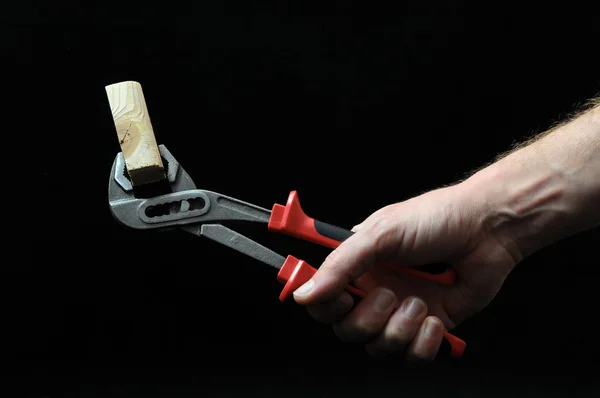 Pliers and a Hand — Stock Photo, Image