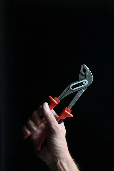 Pliers and a Hand — Stock Photo, Image