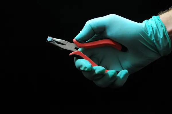 Pliers and a Hand — Stock Photo, Image