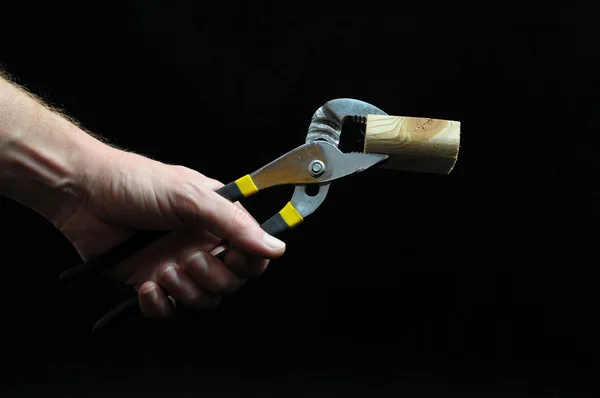 Pliers and a Hand — Stock Photo, Image