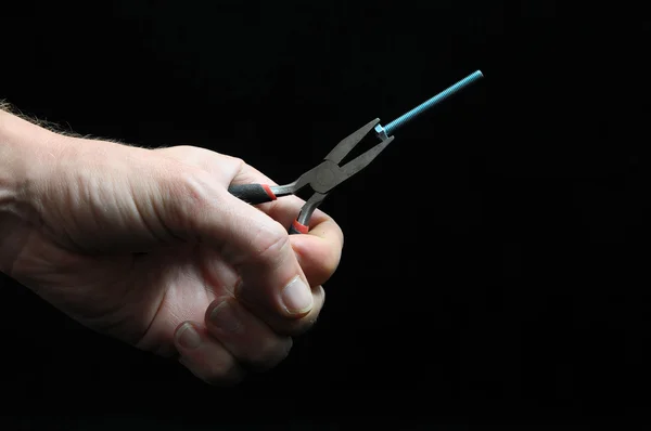 Pliers and a Hand — Stock Photo, Image