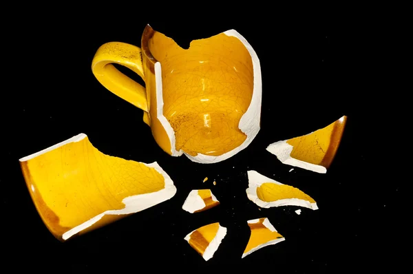 Kaputte orange Kaffeetasse — Stockfoto