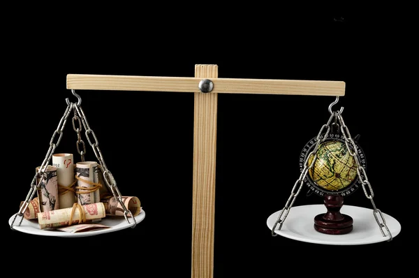 Earth and Money on a Two Pan Balance — Stock Photo, Image