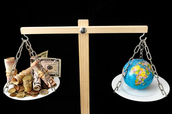 Earth and Money on a Two Pan Balance — Stock Photo, Image