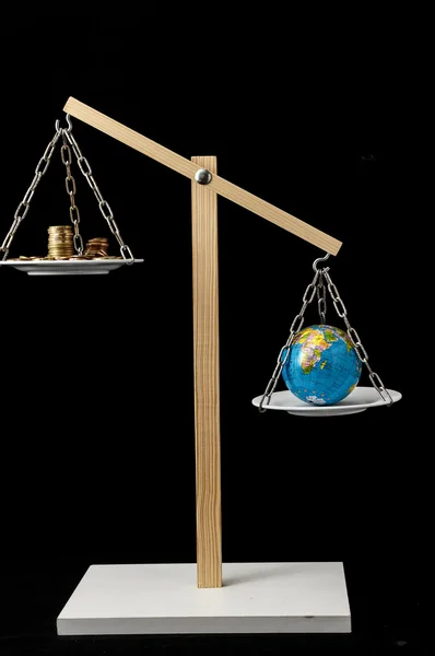 Earth and Money on a Two Pan Balance — Stock Photo, Image