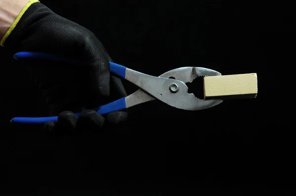 Pliers and a Hand — Stock Photo, Image