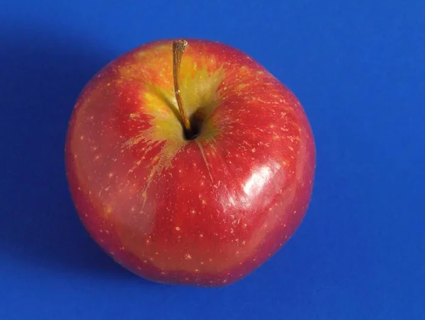 Ein Saftig Roter Apfel Vor Farbigem Hintergrund — Stockfoto