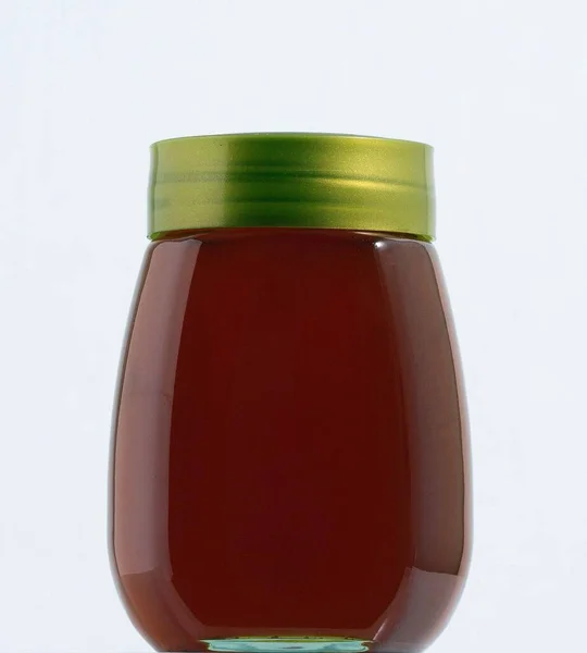 Een Volledige Honing Pot Een Witte Achtergrond — Stockfoto