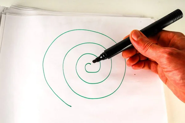 hand drawing a spiral on a white background