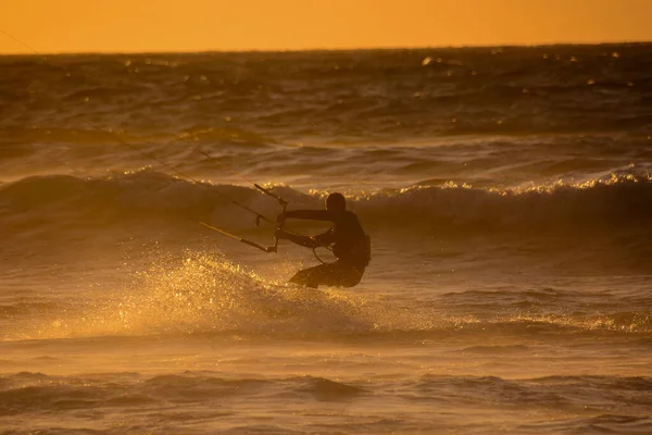 Single surfer at sunset on a calm ocean