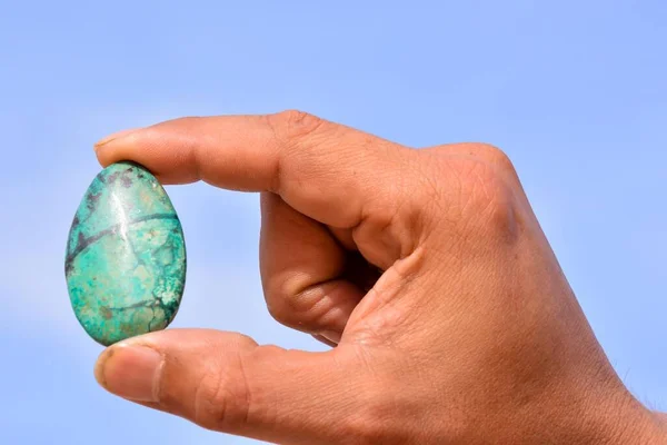 Close Hand Holding Gemstones Isolated Blue Background — Fotografia de Stock