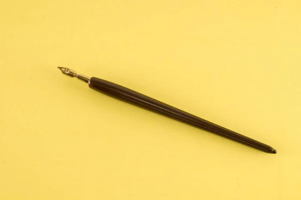 黄色の背景にペンを — ストック写真