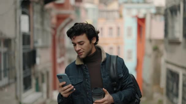 Turista árabe usando smartphone mientras camina por la calle — Vídeo de stock
