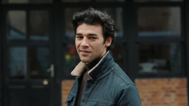 Hombre árabe en ropa casual sonriendo en la cámara al aire libre — Vídeos de Stock