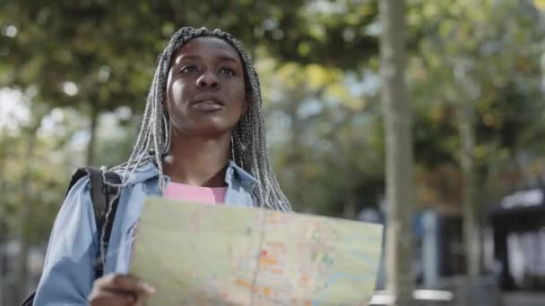 Boldog afro-amerikai nő használja a térképet a város utcáján — Stock videók