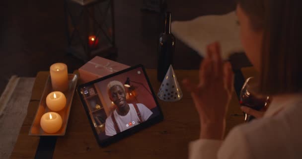 Multiracial couple having date through video call on tablet — стоковое видео