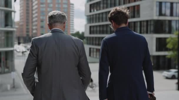 Business colleagues in suits walking down on stairs — Vídeo de Stock