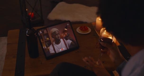 African man and woman tasting red wine during video call — Vídeo de Stock