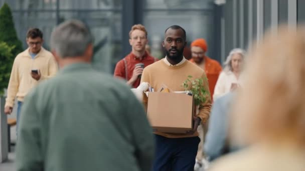 African american man carrying box with office stuff — Vídeos de Stock