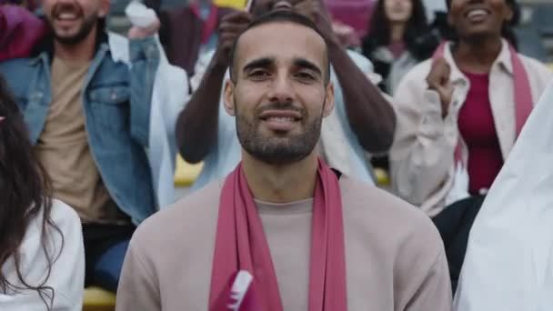 Arabian man looking at camera during football game — Stock videók