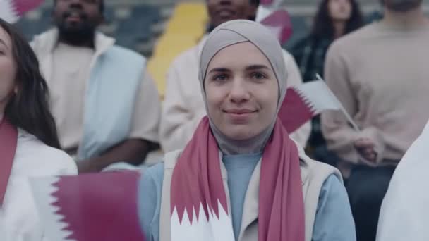 Muslim woman in hijab watching football game on stadium — 图库视频影像