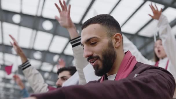 Guy raising hands and shouting while watching soccer game — Video