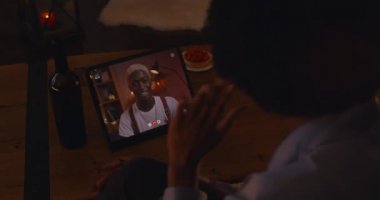 African couple using tablet for online dating at home