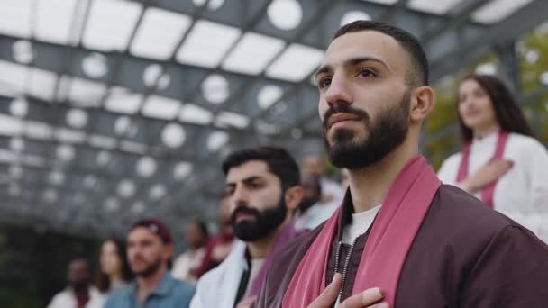 Muslim man listening anthem and applauding on soccer match — стокове відео