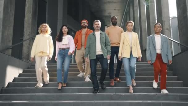 Multiracial business colleagues walking down on stairs — Videoclip de stoc