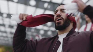 Arabian guy supporting national team during soccer match