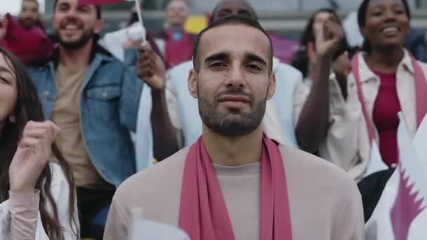 Muslim guy cheering during football match on stadium — Vídeo de Stock