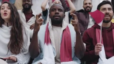 Excited african american man cheering during soccer game