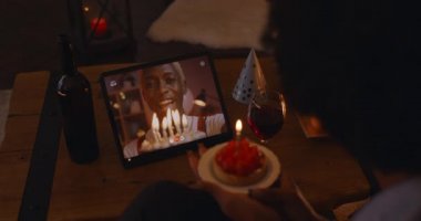 African lady celebrating birthday with man during video call