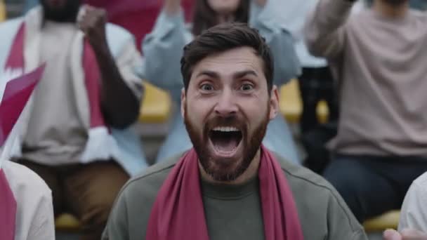 Bearded man emotionally cheering during soccer game — стоковое видео