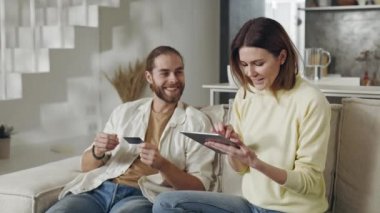 Mutlu çift evde online alışveriş yapıyor.