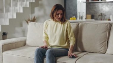 Worried woman waiting for some news on her mobile phone