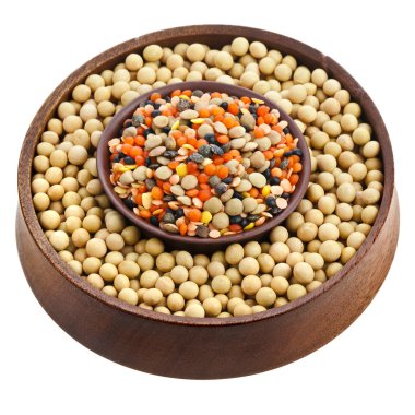 Soybean and a variation of lentils in a wooden bowl isolated on white background