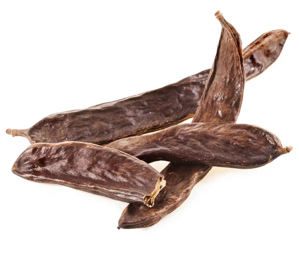 Carob brown dried husks as aromatic condiment for bakery — Stock Photo