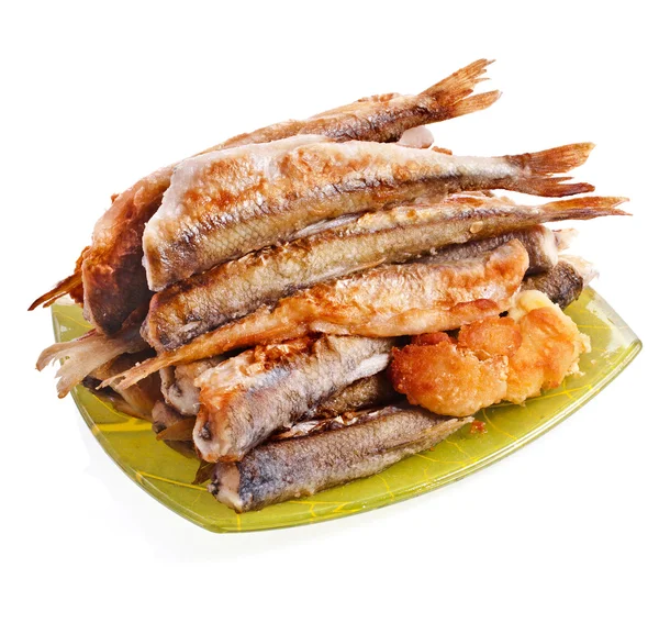 Fried smelts Baltic fish on a dish — Stock Image Fried smelts Baltic fish on a dish Royalty Free Stock Photos