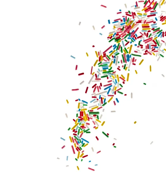 Border frame of colorful candy sprinkles isolated on white background