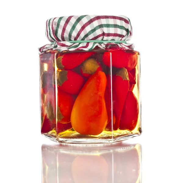 Preserved red hot pepper with reflection in glass jar close up isolated on a white background — Stock Image Preserved red hot pepper with reflection in glass jar close up isolated on a white background Royalty Free Stock Images