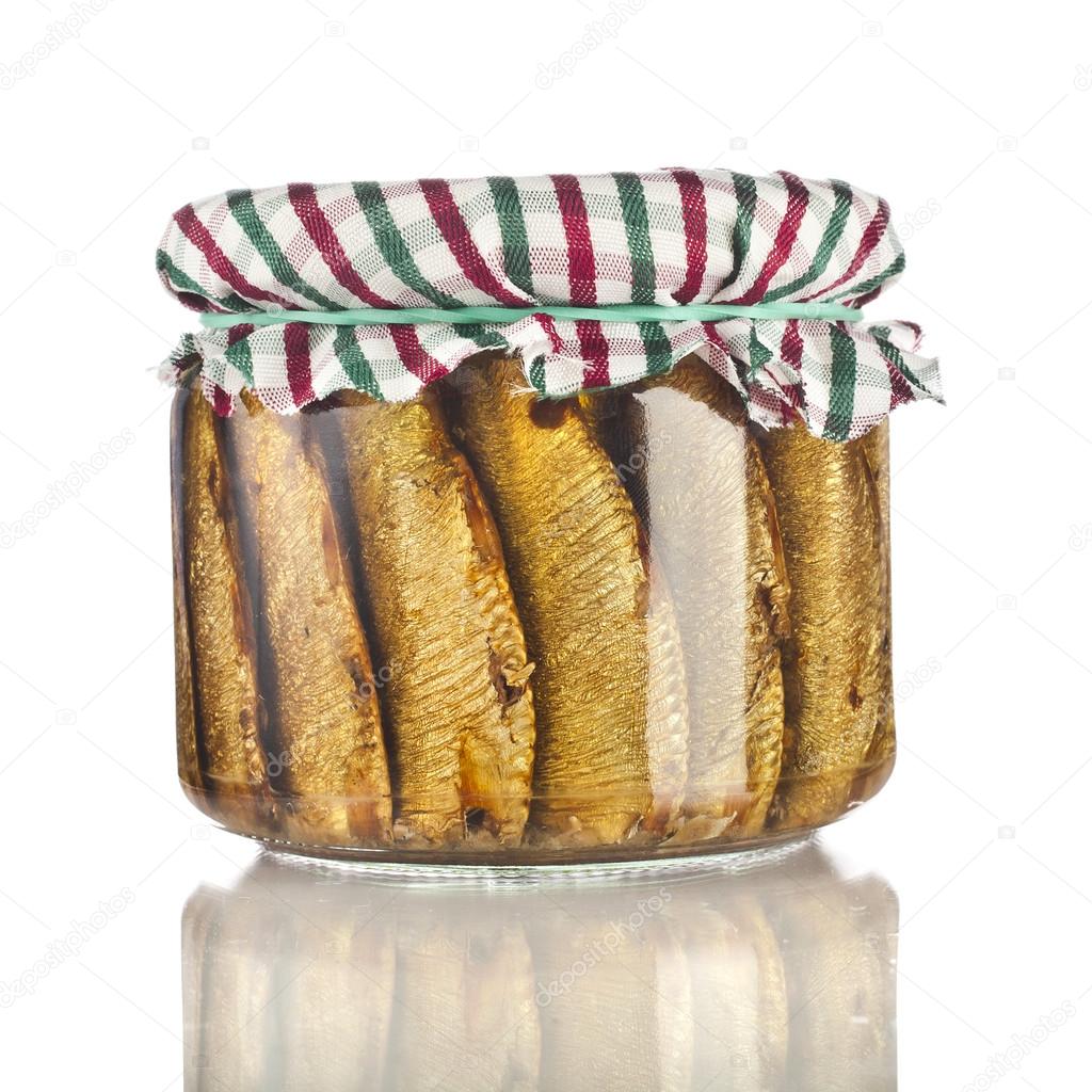 Sardines fishes with oil conserved in glass jar close up isolated on