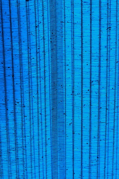 Luifels blauw doek achtergrond. — Stockfoto