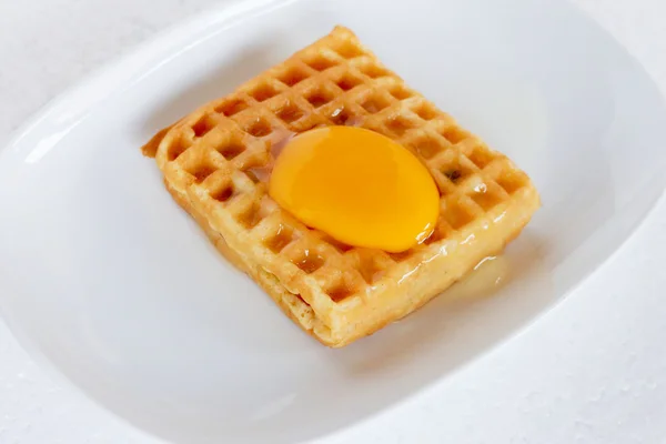 Waffle topped with egg yolk. — Stock Photo, Image