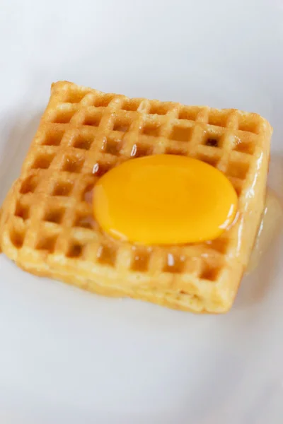 Waffle topped with egg yolk. — Stock Photo, Image